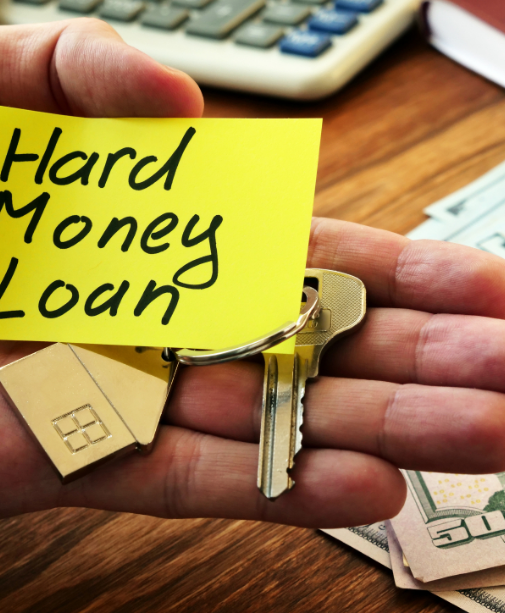 A hand holding keys to a home from a hard money loan