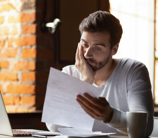 A person holding a piece of paper showing the details of their current online personal loan for people with bad credit