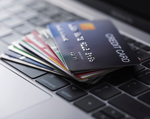 A stack of credit card on a computer to show how a personal line of credit is similar to how a credit card works