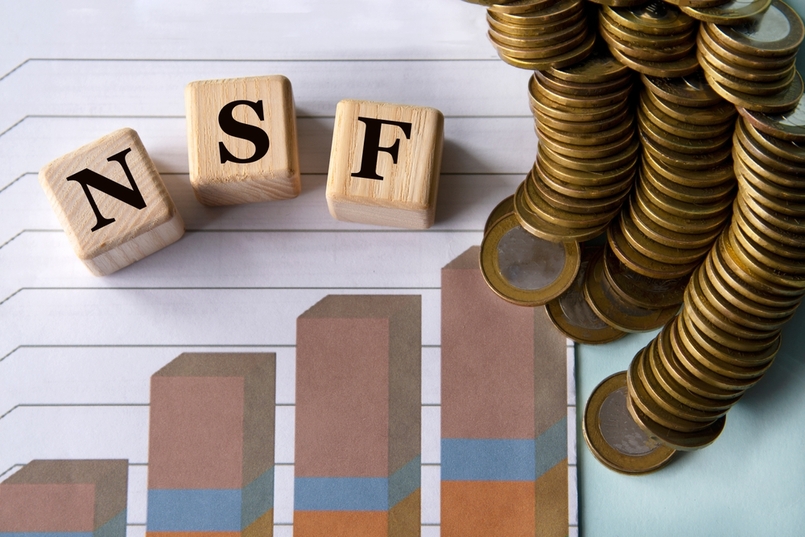 Row of coins and chart explaining what is a non-sufficient funds (nsf) fee