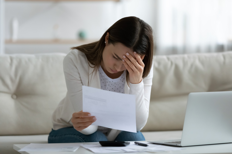 woman holding a document wonder what is a loan origination fee and what her options are regarding the fee