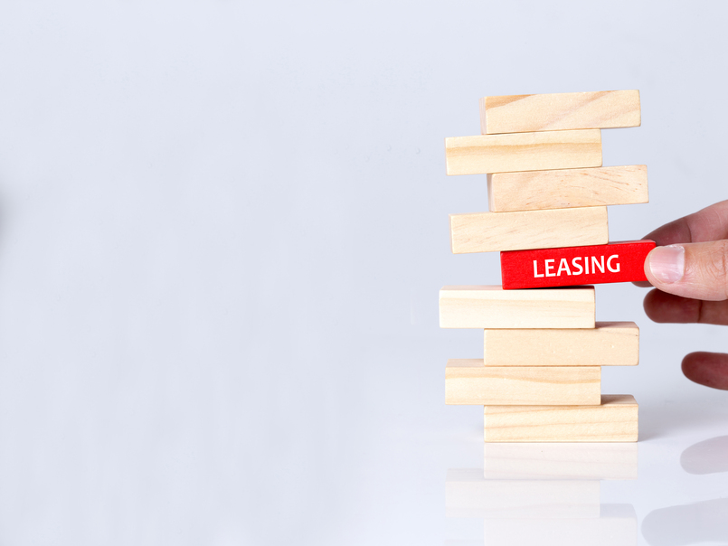 a person pulling one block out of stack to illustrate how breaking a lease might affect your credit