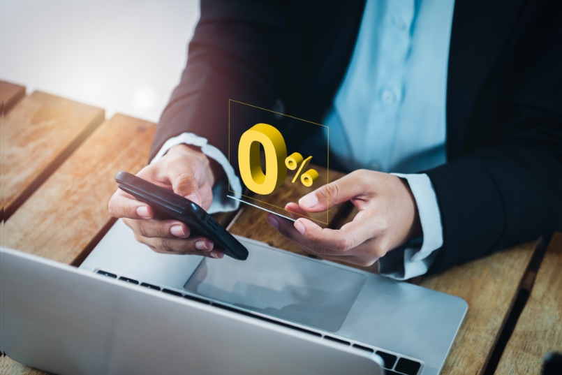 a man holding a credit card while researching how credit card interest works