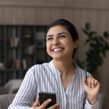 Woman holding a credit card shopping on her phone
