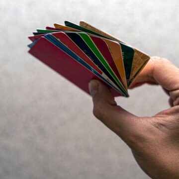 Hand holding multiple different credit cards
