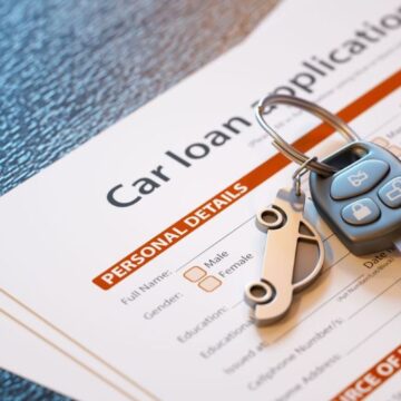 Car loan application form with car key sat on top of the form