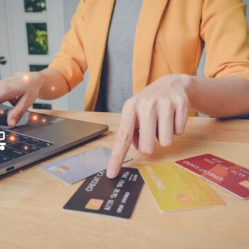 Businesswoman using a laptop and choosing the best credit card