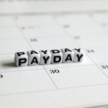 White dice like cubes that spell the word payday