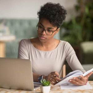 Woman filling out an online loan application from home.