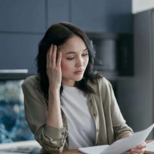 Woman calculating her finances.