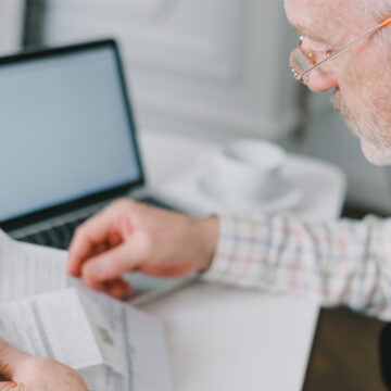 An elderly man examining finances related to retirement savings