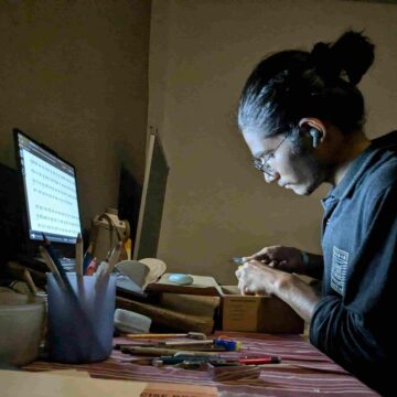 Man working on a side hustle on their laptop.